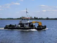 Multicat multipurpose vessel with hydraulic crane & spud pole legs